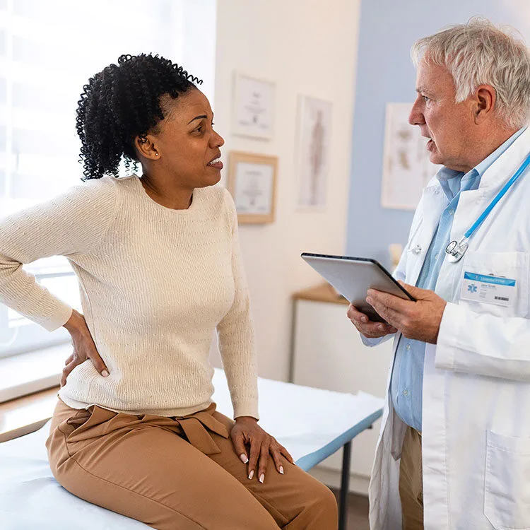 OMD patient discussing pain with doctor web