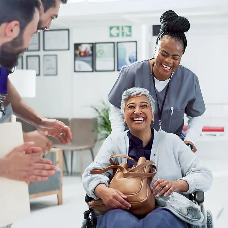 Applause for patient in wheelchair for recovery web