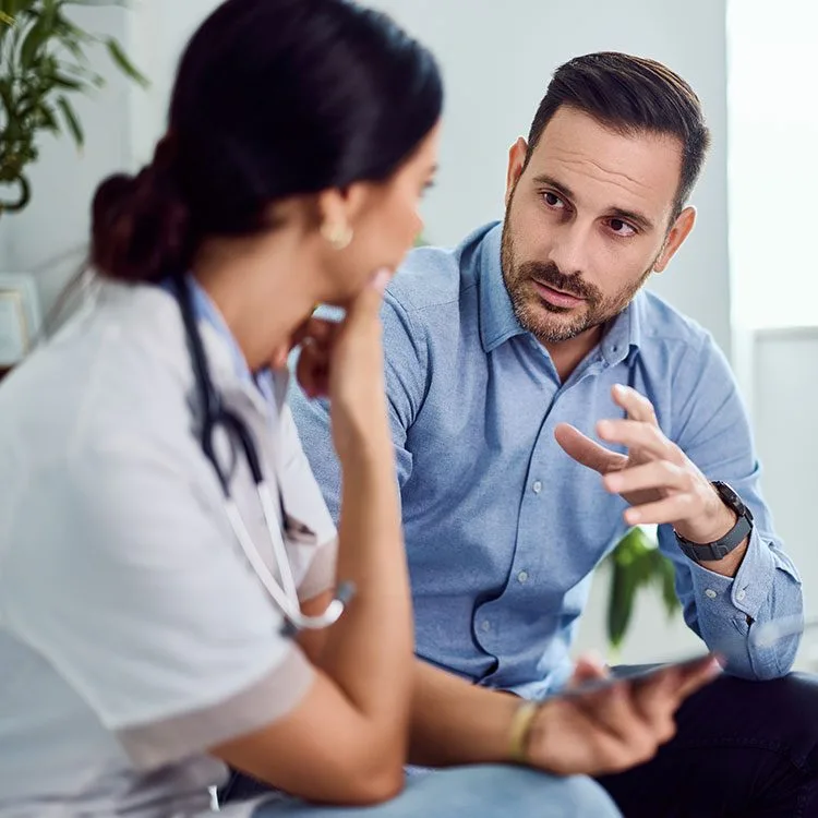 Doctor and patient engaged in a discussion in a modern medical office web