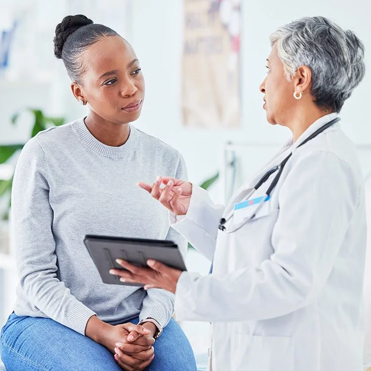 Doctor consults tablet to help advice patient web