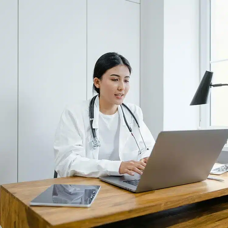Doctor using a macbook web