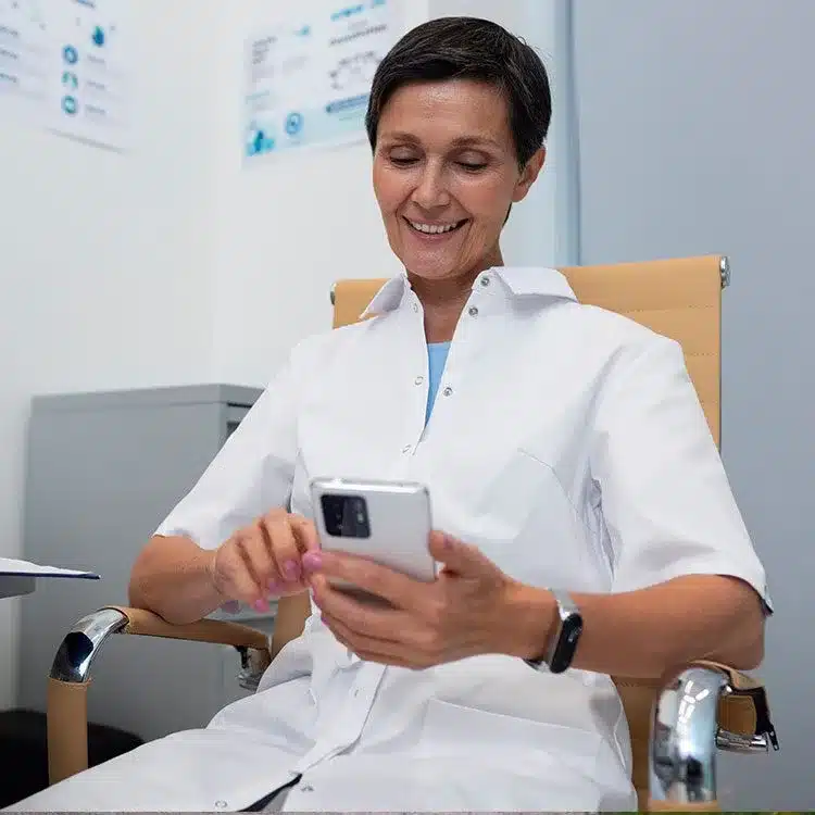 Doctor using mobile device in office web