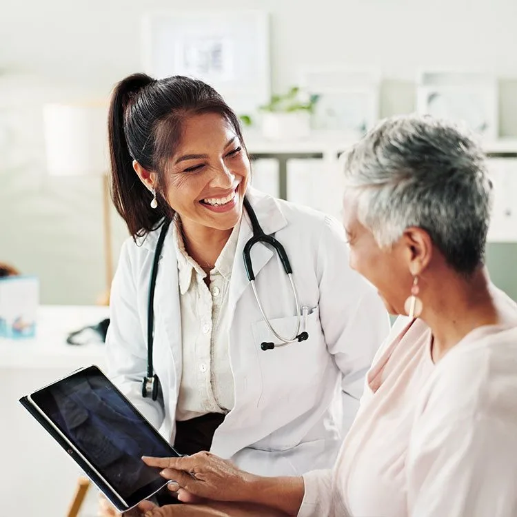 Doctor using tablet in conversation with patient web