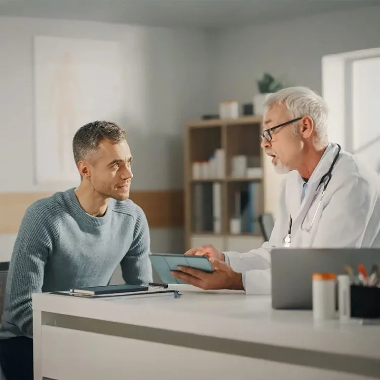 Experienced middle aged doctor showing results on tablet computer web