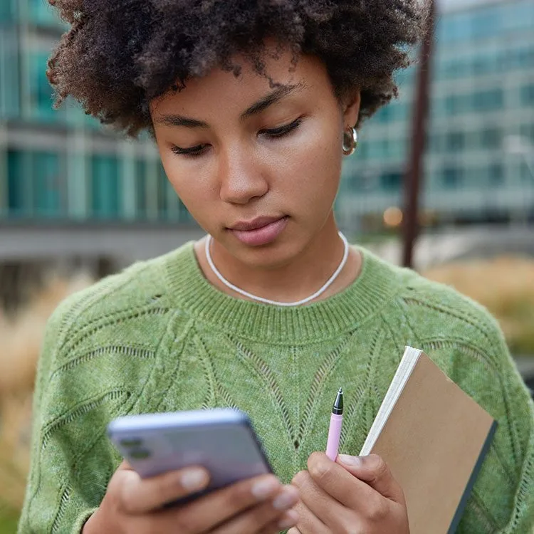 Female concentrates on smartphone screen web