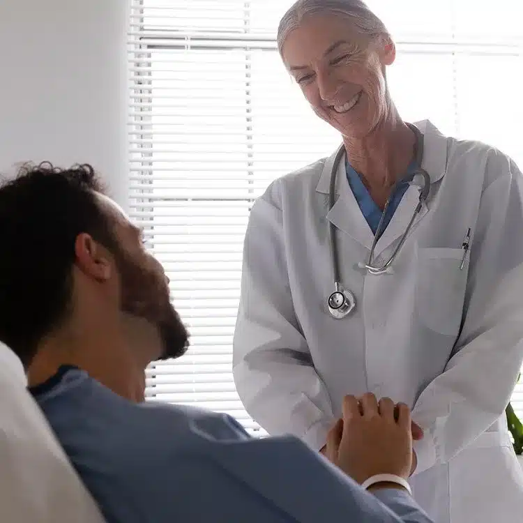 Male patient bed talking nurse web
