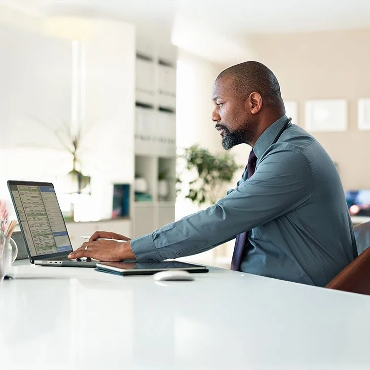 Medical office staffer entering information into a computer web
