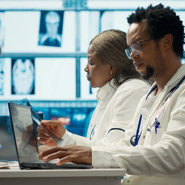 Physicians examining x ray scan results meeting with staff web