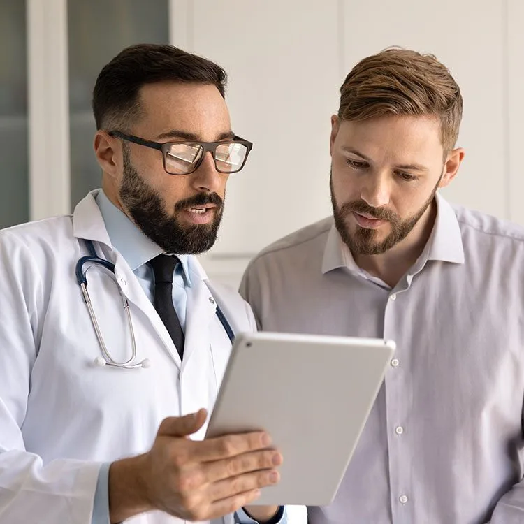 Serious medical practitioner and patient looking at medical report web