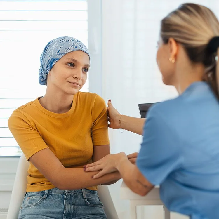 Teenage oncology patient talking with doctor web