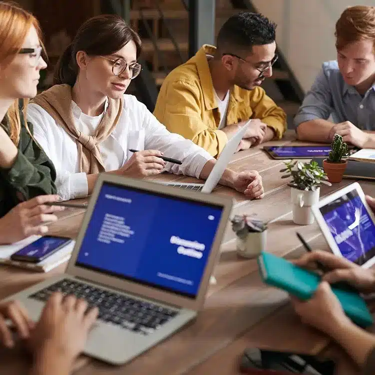 Workers collaborating across a table web